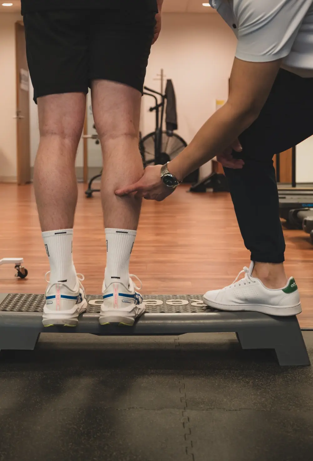 Physiotherapist performing hands-on assessment with patient